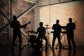 Music band and fashion. Handsome young men in suits playing rock and singing song. Bands silhouettes with on a concert. Royalty Free Stock Photo