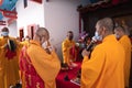 Chief monks doing greetings to the god while praying