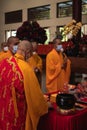 The chief monks and the monks use a mic while talking and praying to the congregation