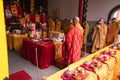 Bandung, Indonesia - January 8, 2022 : A Group of monks with orange and red robes praying together at the altar