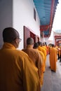 The monks escort the visitors and congregation while praying