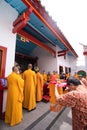The monks escort the visitors and congregation while praying