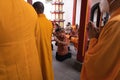 The monks standing between the visitors