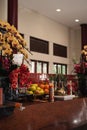 Bandung, Indonesia - January 8, 2022 : The offerings like food and candle on the top of the red Buddhist table during the praying