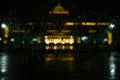 Blurry rainwater and view Gedung Sate building at night.