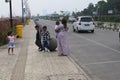 father, mother and child in the middle of a ball-shaped concrete row in the courtyard of the Al Jabbar Mosque in the afternoon