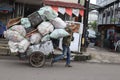 scavengers carrying their carts of used goods across the main road