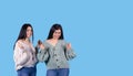 Baner, blue background.Two lovely and smiling ladies, full of emotions, with long hair, straight , black, showing