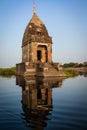 Small Hindu temple in the middle of the holy Narmada River, Maheshwar, Madhya Pradesh state, India