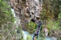 Lower Falls waterfall in Johnston Canyon, Banff National Park Canada, as a long line of