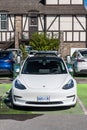 Banff, Alberta, Canada September 20, 2022 A white Tesla parked at a charging station in a parking lot Royalty Free Stock Photo