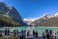 Banff, Canada - Ago 14th 2017 - Group of tourists in front of Lake Moraine in the early morning. Blue sky, mountains in the backgr Royalty Free Stock Photo