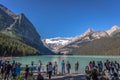 Banff, Canada - Ago 14th 2017 - Group of tourists in front of Lake Moraine in the early morning. Blue sky, mountains in the backgr