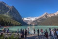 Banff, Canada - Ago 14th 2017 - Group of tourists in front of Lake Moraine in the early morning. Blue sky, mountains in the backgr Royalty Free Stock Photo