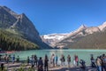 Banff, Canada - Ago 14th 2017 - Group of tourists in front of Lake Moraine in the early morning. Blue sky, mountains in the backgr Royalty Free Stock Photo