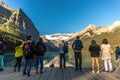 Banff, Canada - Ago 14th 2017 - Group of tourists in front of Lake Moraine in the early morning. Blue sky, mountains in the backgr Royalty Free Stock Photo