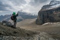 Banff, Canada - 08.30.2018: Man taking a photo of Mt. Lefroy and glacial moraine below at the end of Plain of Six Glaciers trail, Royalty Free Stock Photo