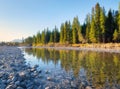 Banff National Park, Alberta, Canada. Lake and forest in a mountain valley at the morning. Natural landscape with bright sunshine. Royalty Free Stock Photo