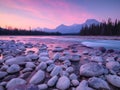 Banff National Park, Alberta, Canada. Landscape during sunrise. Round rocks on the riverbank. Mountains and forest. Vivid colours
