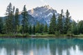 Banff National Park beautiful scenery. Cascade Mountain and pine trees reflected on turquoise color Bow River in summer time Royalty Free Stock Photo