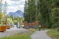 Banff Town Sign in summer time. Tourist cycling in Banff Legacy Trail. Banff National Park