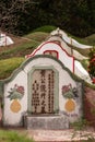 Tombstone with flower decorarions at Chao Pho Khao Chalak Cemetery, Bang Phra, Thailand Royalty Free Stock Photo