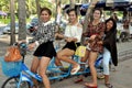 Bang Saen, Thailand: Four Thai Women Riding a Bicycle