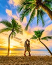 Bang Tao beach Phuket Thailand, Couple of men and women watching sunset on the beach Royalty Free Stock Photo