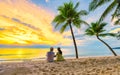 Bang Tao beach Phuket Thailand, Couple of men and women watching sunset on the beach Royalty Free Stock Photo