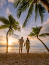 Bang Tao beach Phuket Thailand, Couple of men and women watching sunset on the beach Royalty Free Stock Photo