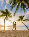 Bang Tao beach Phuket Thailand, Couple of men and women watching sunset on the beach Royalty Free Stock Photo