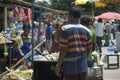 Bangalore, India : A female seller of sugarcane juice serving fresh juice to customer in a market place