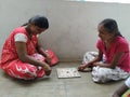 Beautiful Indian Girls Playing Chowka Bhara Game during Corona Virus or Covid 19 Disease spread Holiday for Timepass in front of