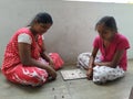 Beautiful Indian Girls Playing Chowka Bhara Game during Corona Virus or Covid 19 Disease spread Holiday for Timepass in front of