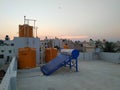 Beautiful view of Sunset at the top of the house terrace and Water tank and Solar Geyser Panel Fixed in a top of the building