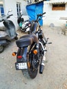 Closeup of Two Wheeler Black Color Harley Davidson parking in a parking lot or in a field Royalty Free Stock Photo