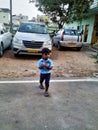 Indian Blue Shirt Wear little Kid in a Big Bazaar Sitting in a Trolley with Cap