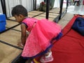 Pink Color Ethnic Dressed Standing Indian Beautiful Girl Child in a Convention Hall During Marriage Ceremony