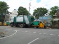 Closeup of BBMP garbage collecting lorry and auto parking on roadside Royalty Free Stock Photo