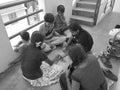 Group of Indian Kids Playing Chowka bhara or Ludo Board Game in Royalty Free Stock Photo