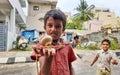 Closeup of different age group kids playing Buguri or Spinning Tops on Roadside during holiday