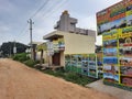 In front of Sri Kamadhenu Kshetra located tourist office arrange tour to place and timing board with flex banner Royalty Free Stock Photo