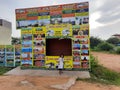 In front of Sri Kamadhenu Kshetra located tourist office arrange tour to place and timing board with flex banner Royalty Free Stock Photo