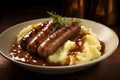 Bangers and mash, a classic pairing of sausages and mashed potatoes, bathed in rich onion gravy