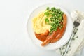 Bangers and mash. Grilled sausages with mash potato and green pea on white plate on light background. Traditional dish of Great Br Royalty Free Stock Photo