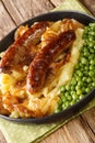 Bangers and Mash With Onion Gravy closeup in the plate. Vertical Royalty Free Stock Photo