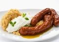 Bangers and mash over white background