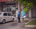 Health worker performing COVID-19 sampling taken from individuals by drive thru at the Quick Test