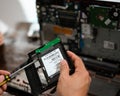 Changing the Hard drive with cd rom inside laptop at home. DIY project at home. Life skill for Royalty Free Stock Photo