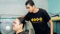 Young teenager applying a hair cream product to straighten the curly hair of his friend